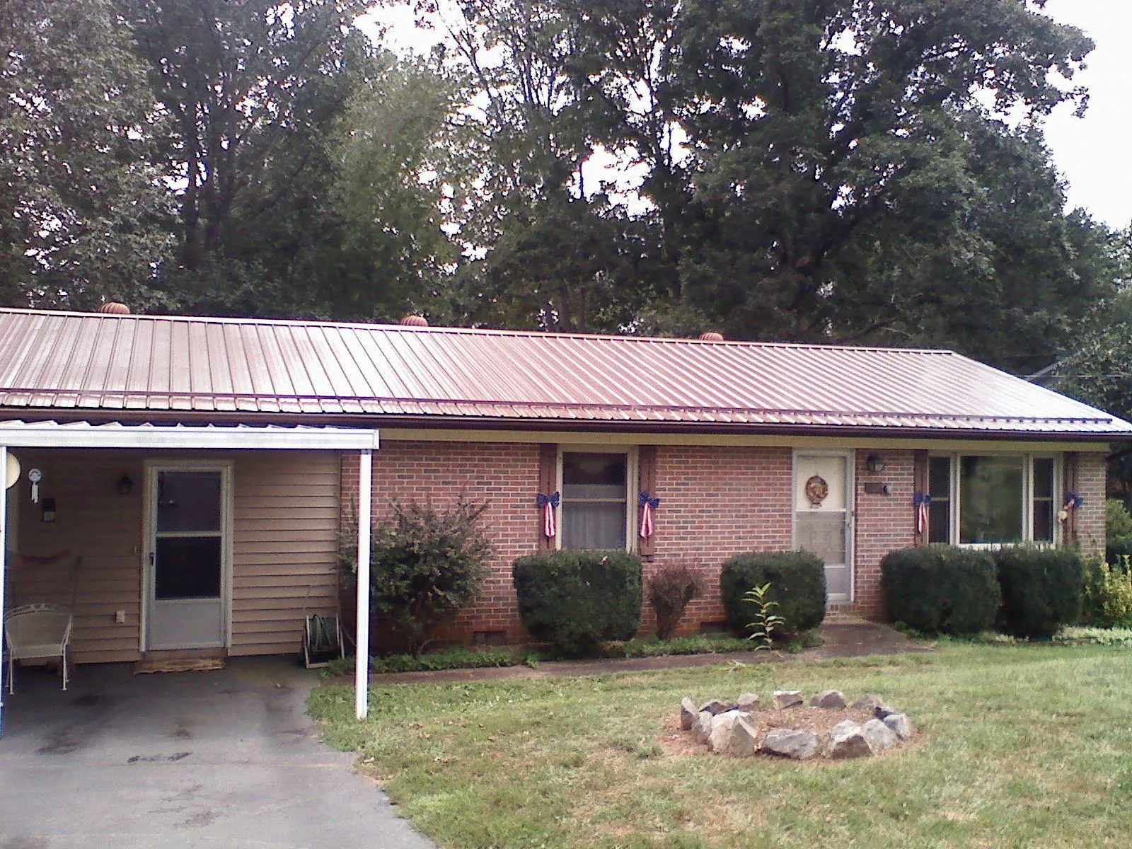 Bronze metal roof and carport on a brick ranch home — Roof Repair work by our crew in Beavertown