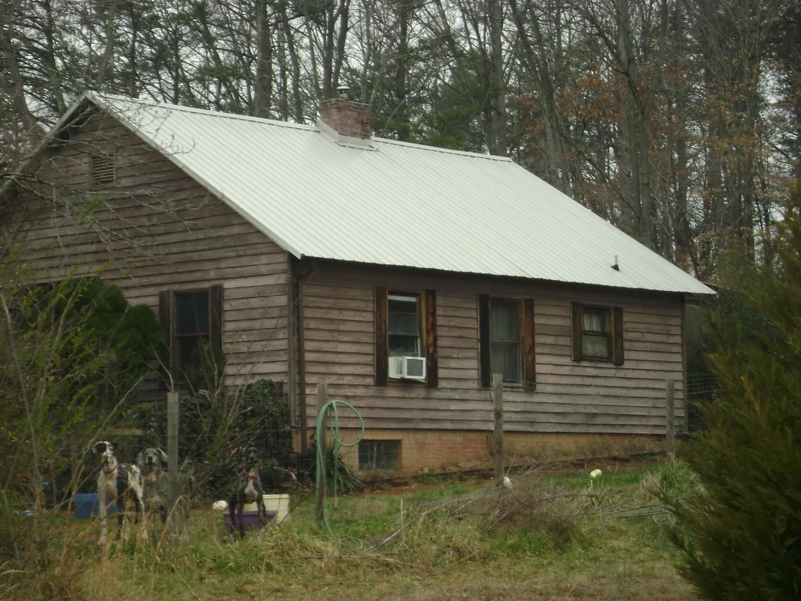 White metal roof on an old wood sided farmhouse, from a Metal Roof Installation job in Beavertown